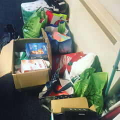 Boxes of products packed for the homeless on the floor next to an electric heater 